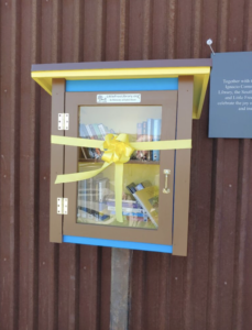 The Little Free Library at Sunnyside Market with her dedication ribbon.