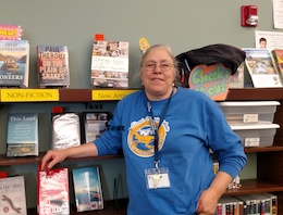 Chris Conrad, Fort Lewis Mesa Librarian, against book shelf